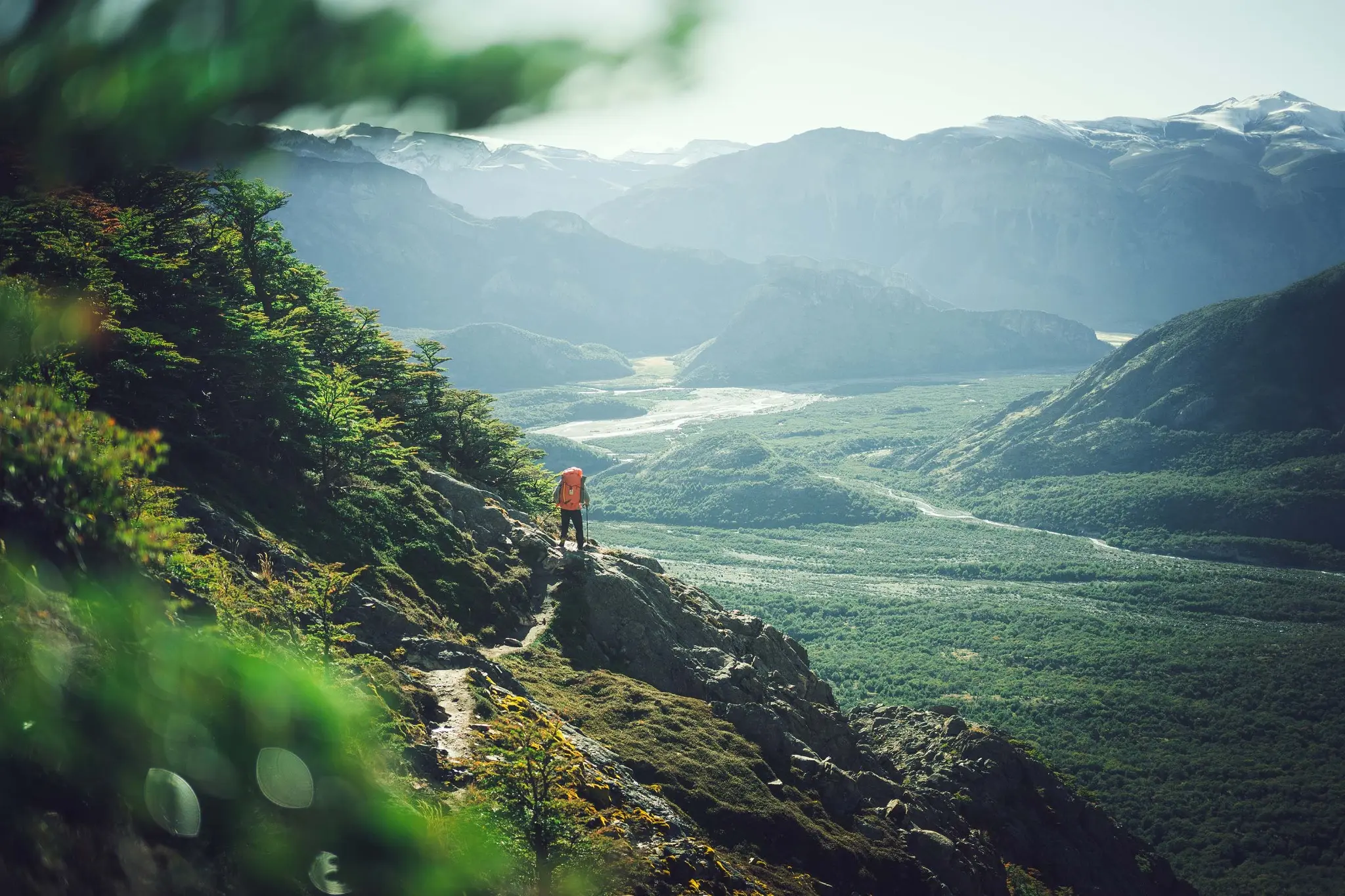 A backcountry traveller overlooking a remote mountain valley